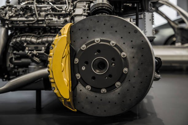 Automobile braking system. Ceramic carbon disk with perforation, ventilation and yellow calipers.